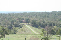 View from main house to lake house with road on south dam
